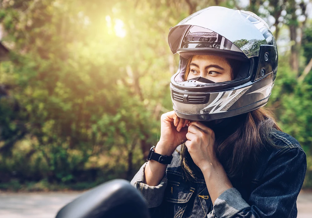 Closeup of woman fastening her motorcycle helmet