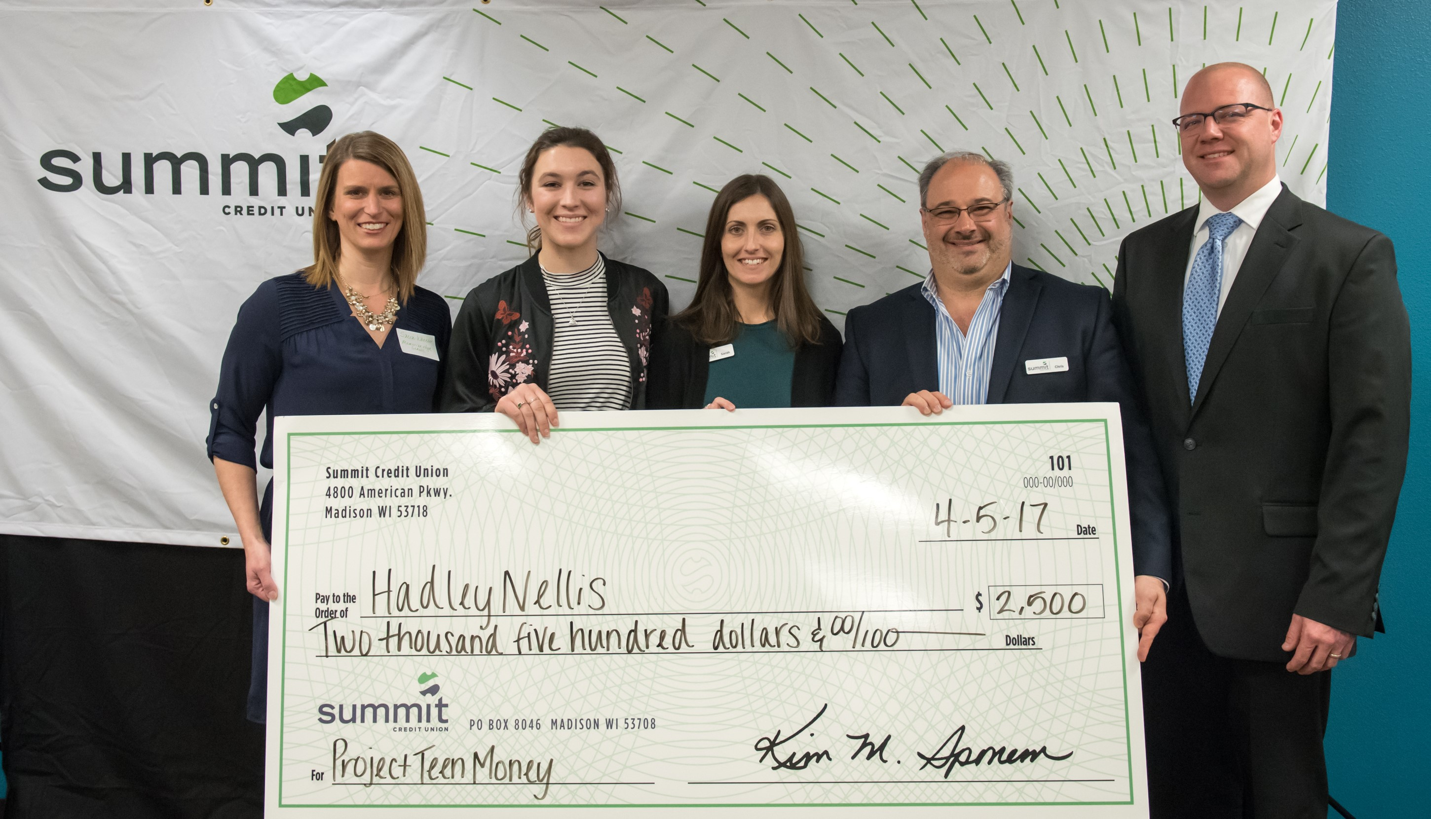 scholarship winner with giant check